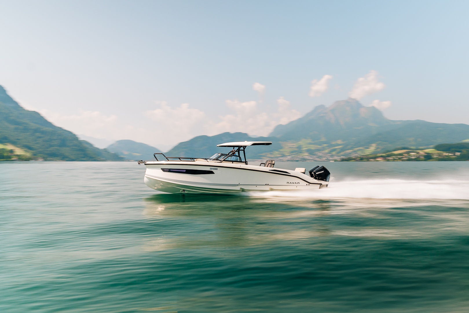A NAVAN S30 on the water with mountains in the background
