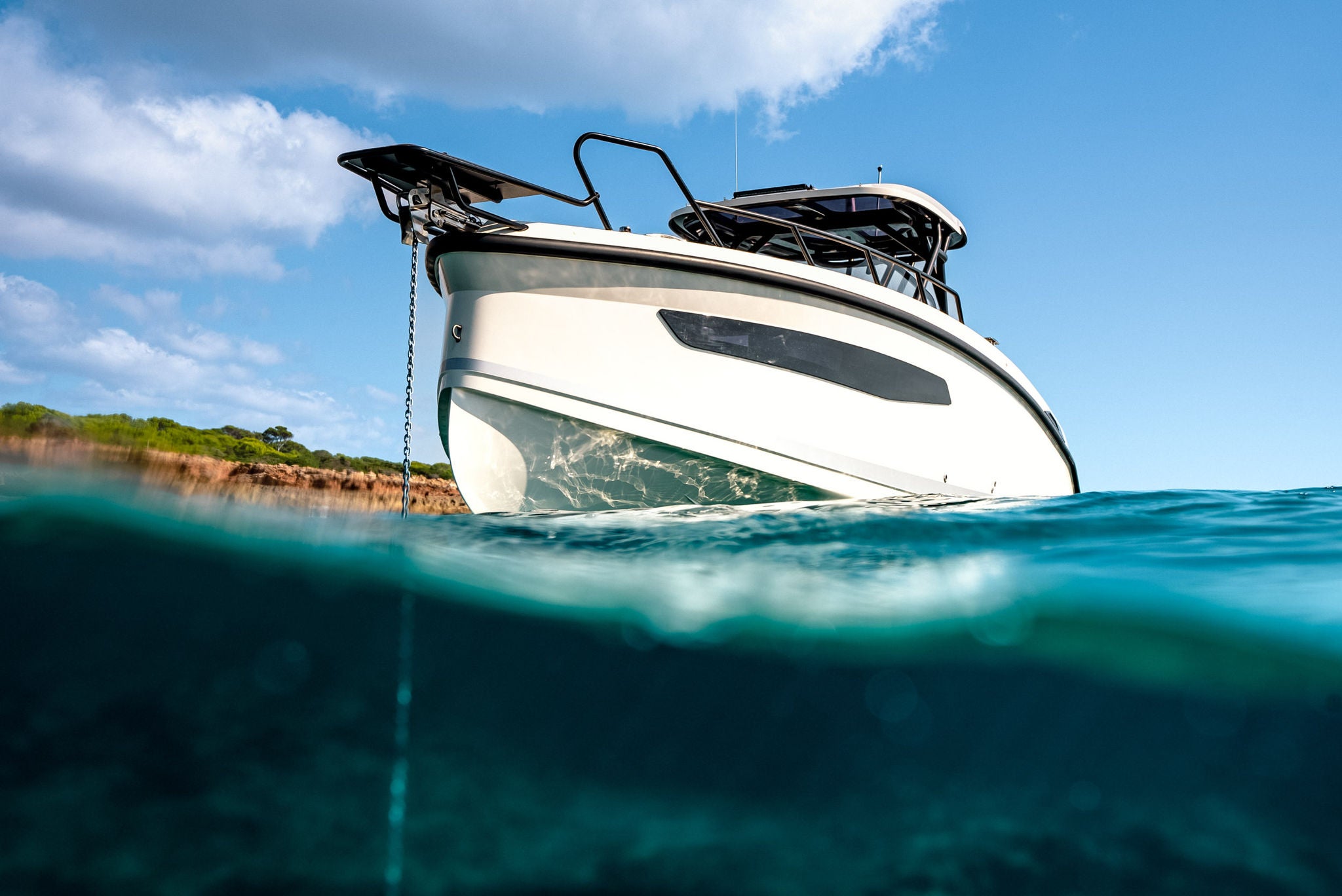 An artistic shot from a low angle of the NAVAN S30 at anchor