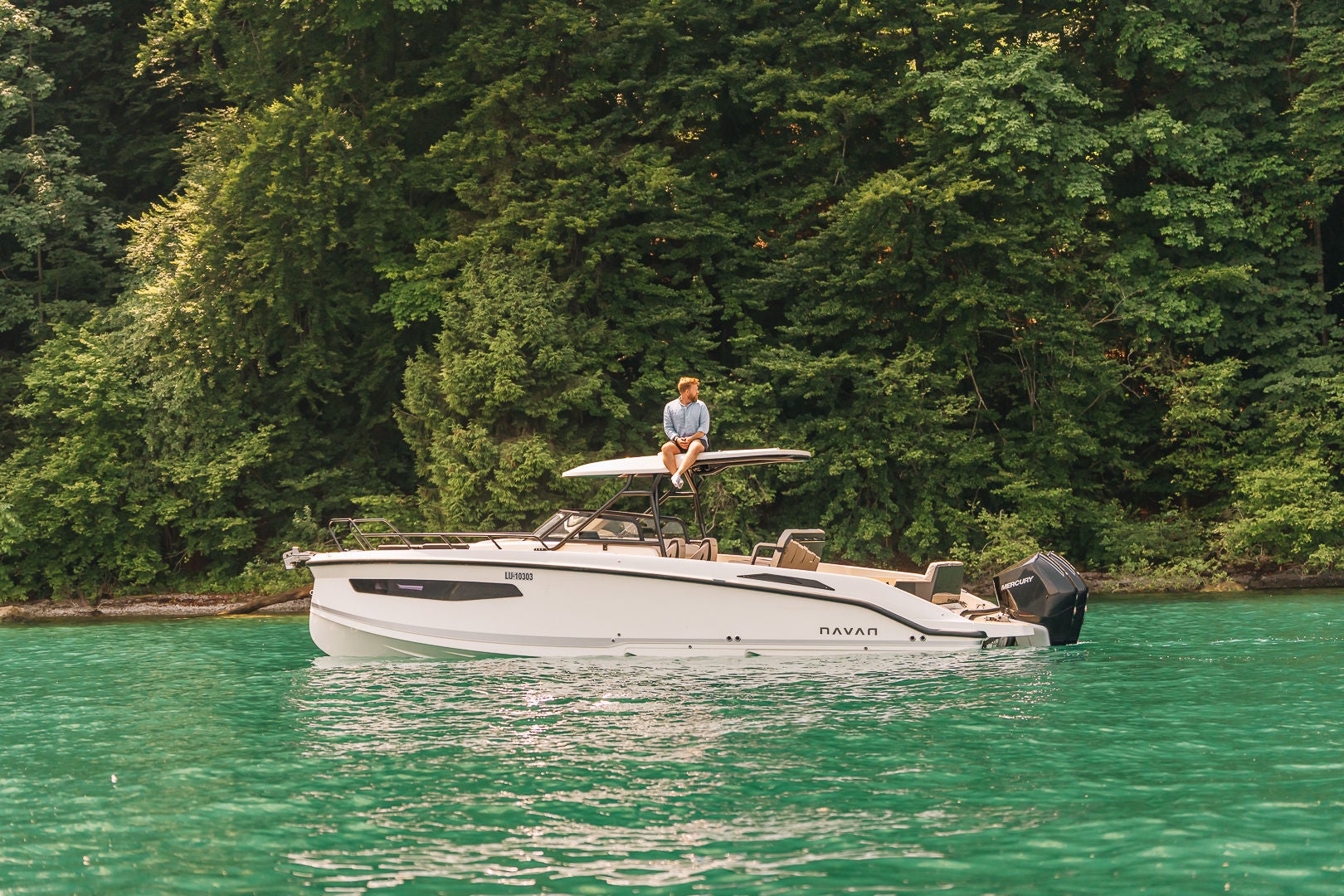 A NAVAN S30 on blue-green waters with a forest in the background