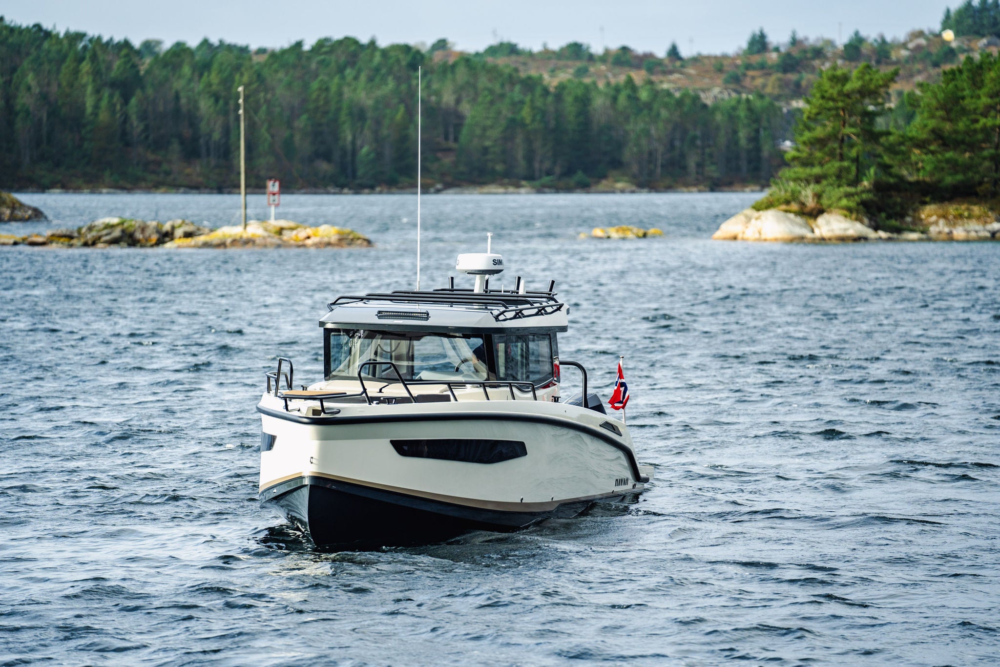 A NAVAN C30 createing huge wakes on the water