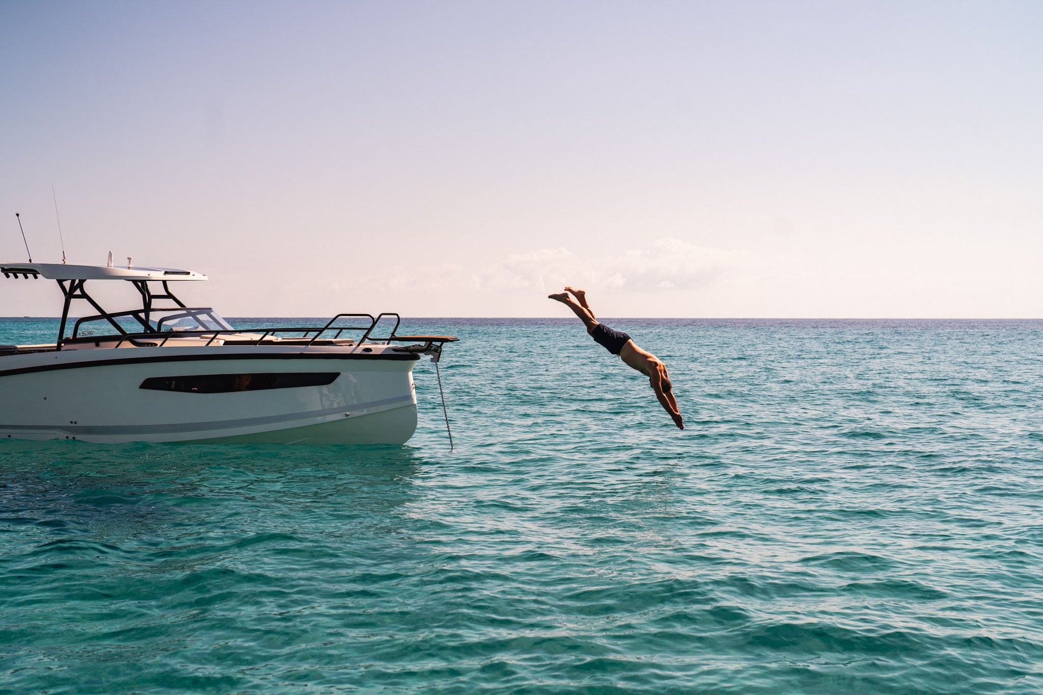 A person diving off of a NAVAN S30 bow