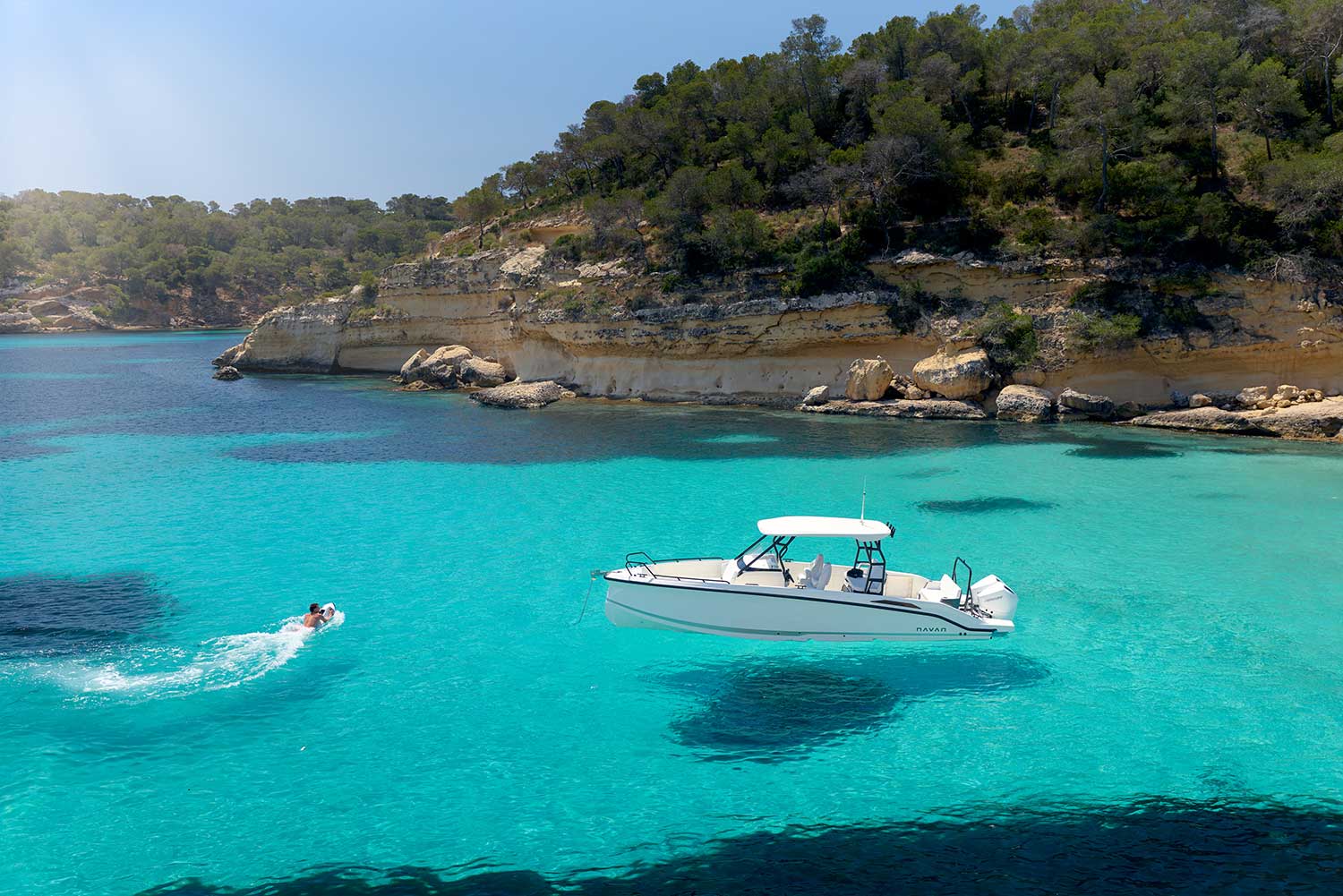 Swimming in tropical blue water next to a Navan T30