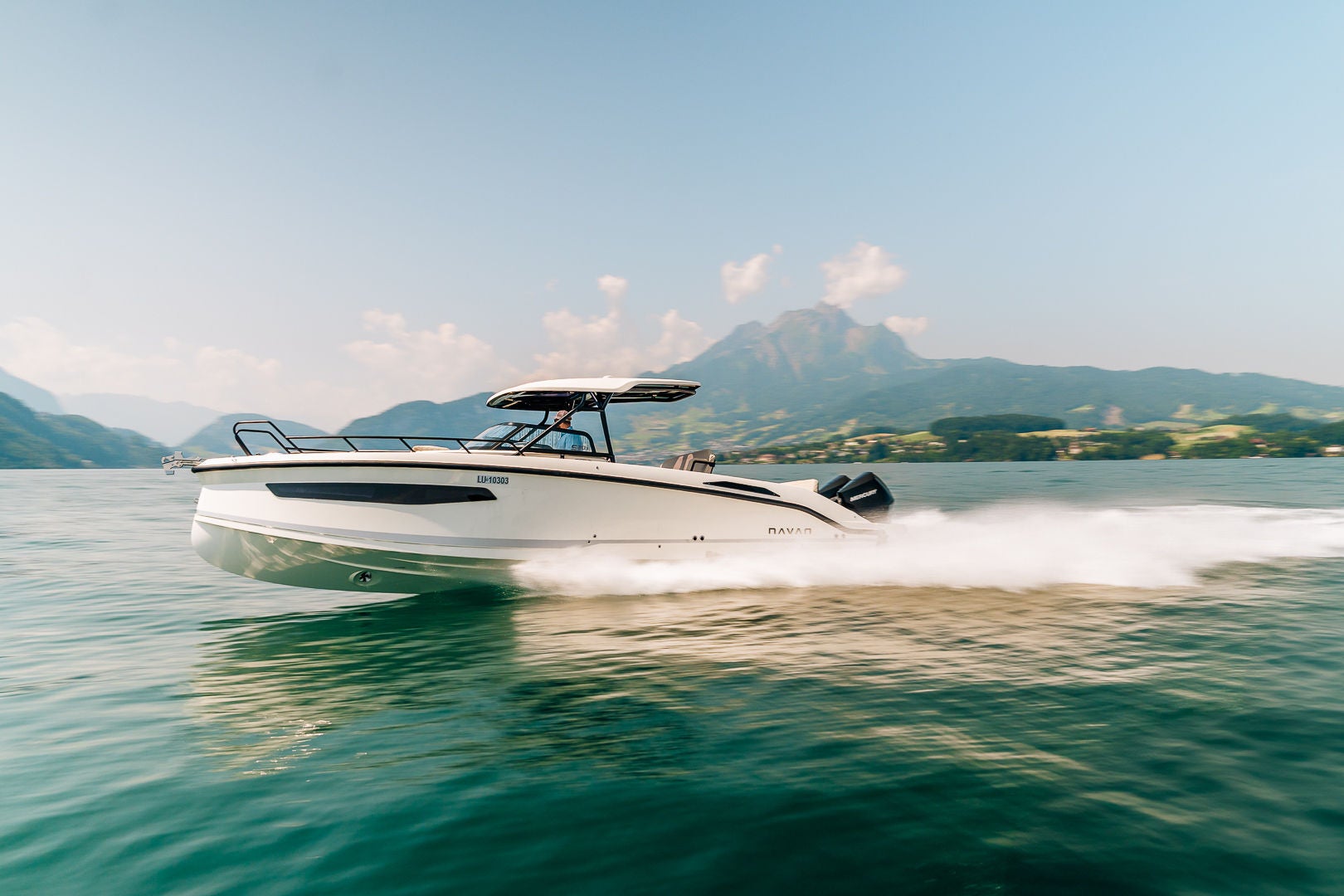 A NAVAN S30 on the water with mountains in the background
